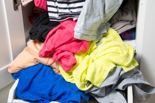 Workers handling office waste and sorting items for disposal