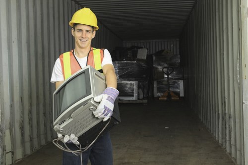 Workers sorting office recyclables into separate bins